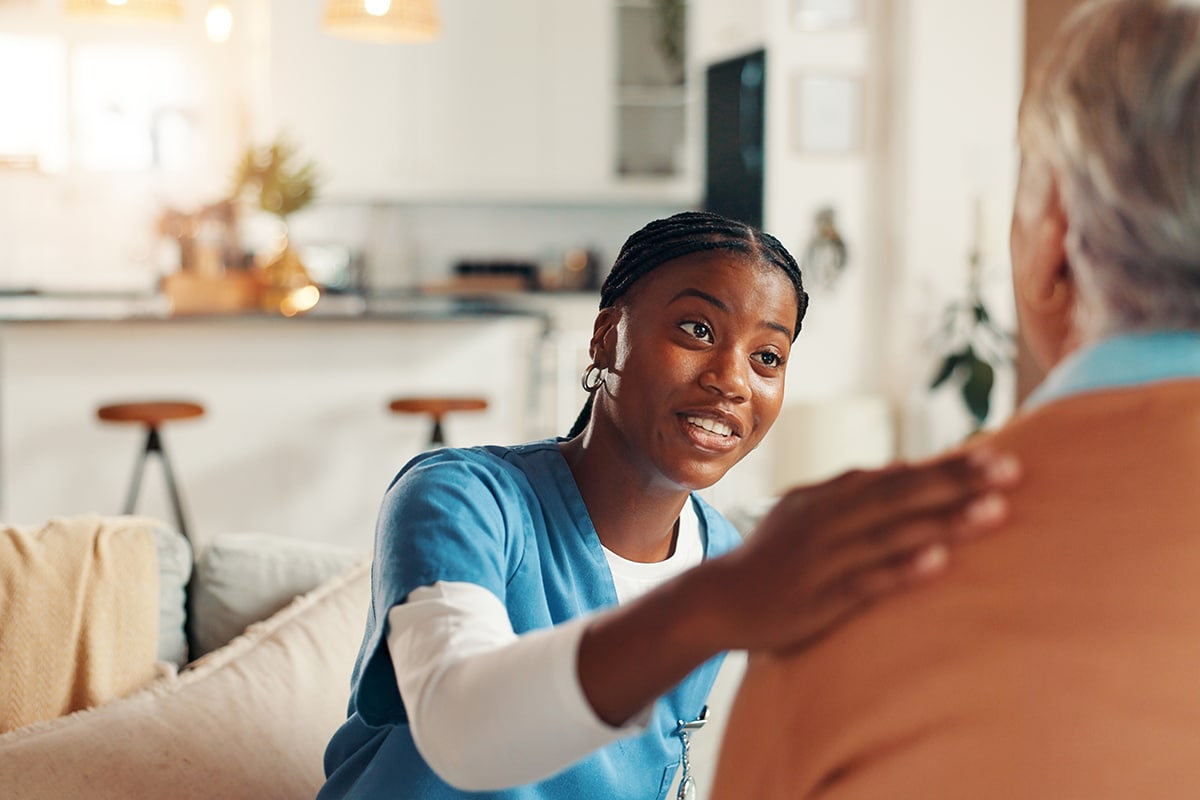Happy, support and nurse with old woman on sofa for Healthcare advice, kindness and trust. Medical caregiver, retirement and consulting with senior patient in nursing home for help and elderly care